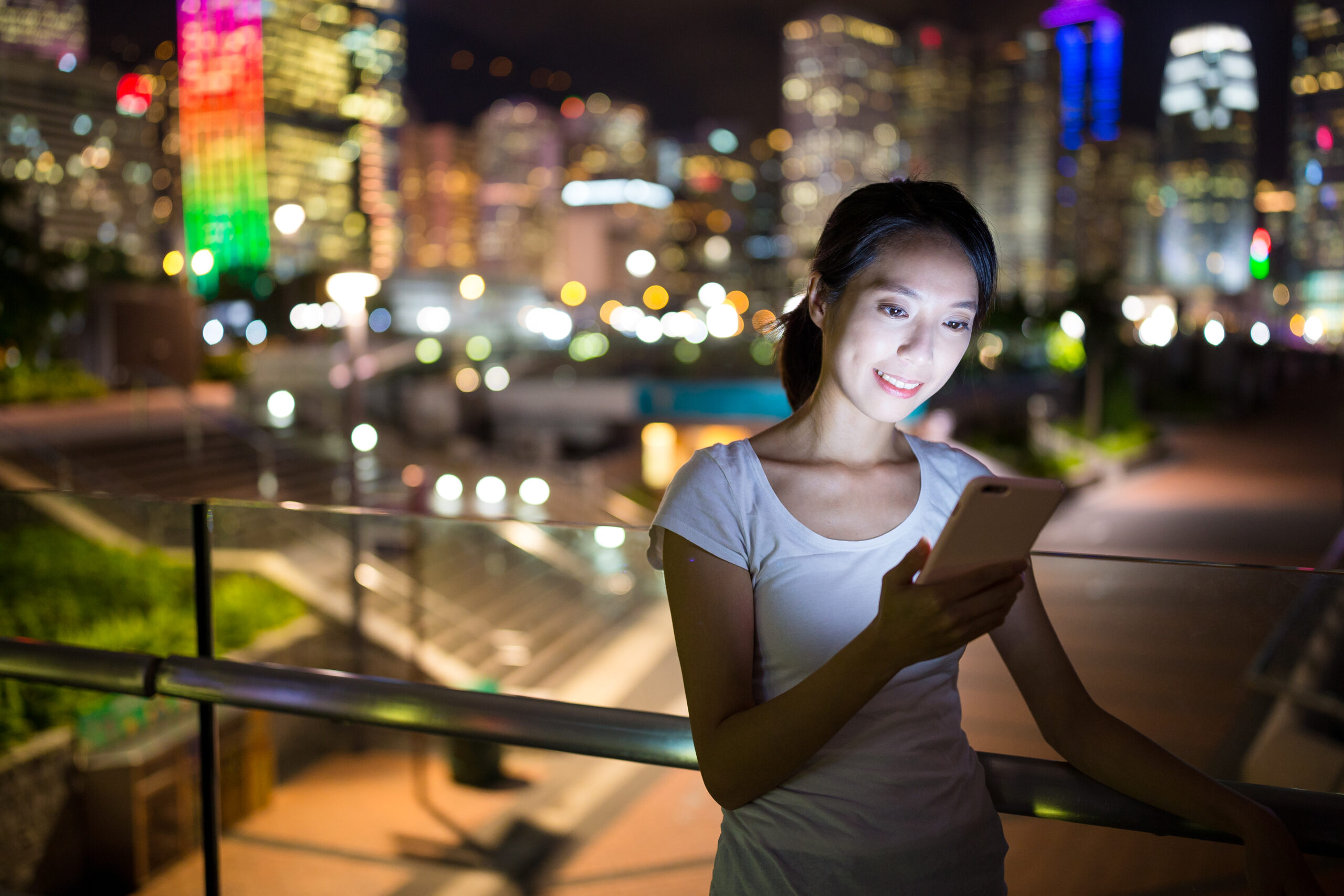 Asian woman use of mobile phone at night
